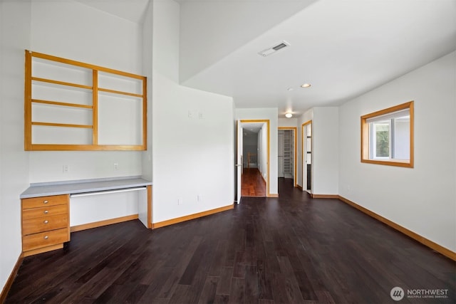 interior space featuring built in desk, visible vents, recessed lighting, dark wood-style flooring, and baseboards