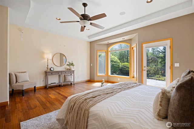 bedroom featuring a ceiling fan, hardwood / wood-style floors, baseboards, access to outside, and recessed lighting