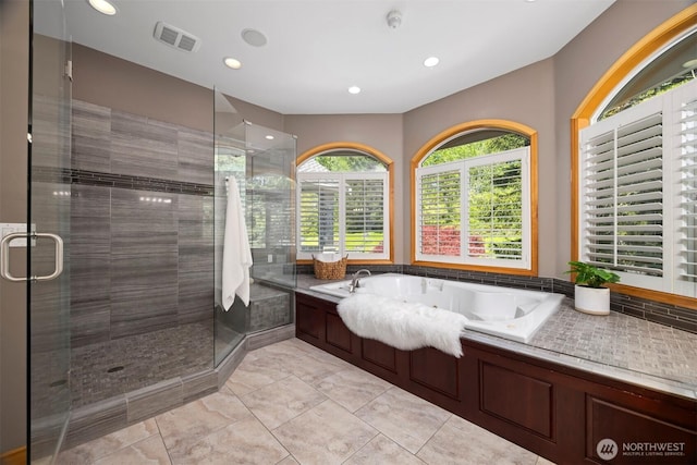 bathroom featuring a tub with jets, a shower stall, visible vents, and recessed lighting