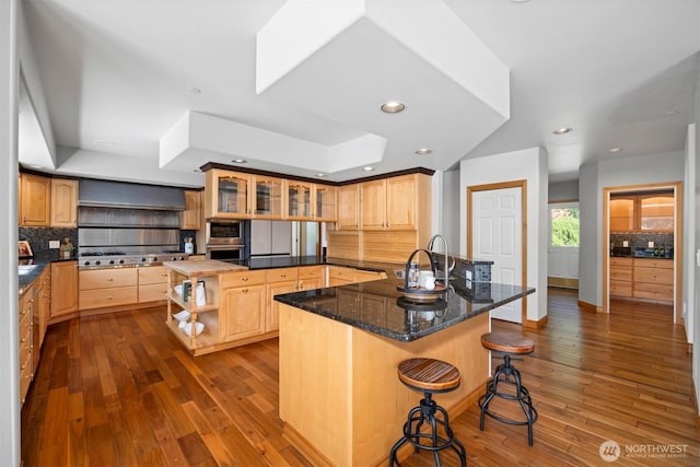 kitchen with a tray ceiling, dark wood-style flooring, open shelves, and backsplash