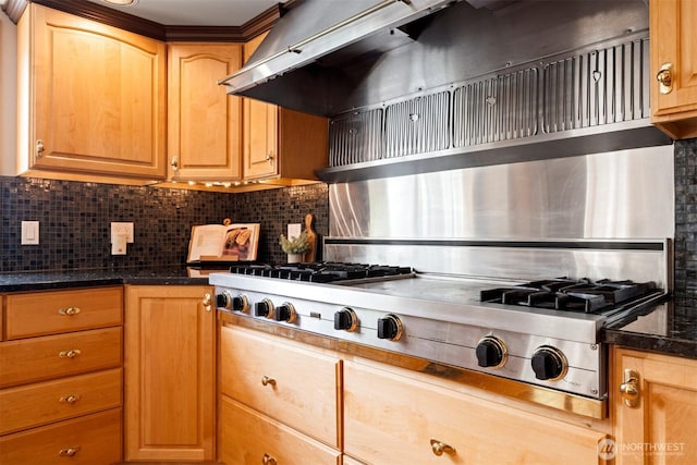 kitchen featuring dark stone counters, light brown cabinets, extractor fan, backsplash, and stainless steel gas stovetop