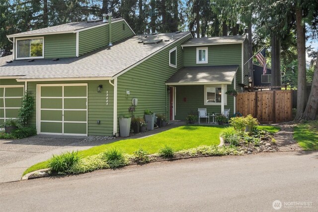 view of front of home with a shingled roof and driveway