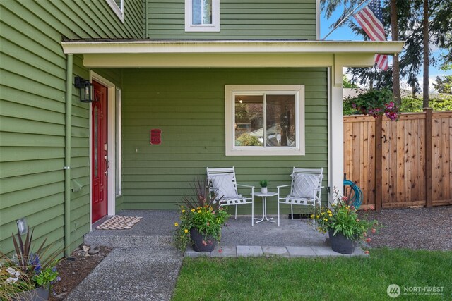 property entrance featuring fence and a patio area