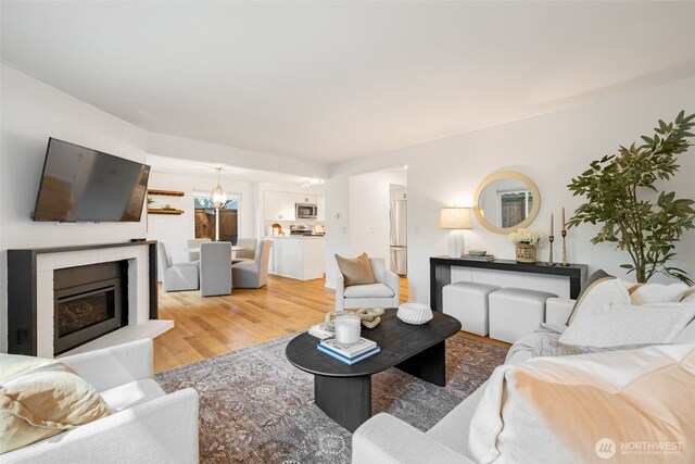 living area with light wood-style floors and a fireplace
