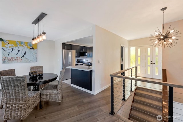 18215 3rd Pl SW, Normandy Park, WA 98166 - dining space featuring a chandelier, dark wood-type flooring, and baseboards
