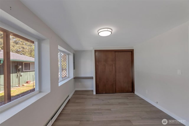 18215 3rd Pl SW, Normandy Park, WA 98166 - interior space with a closet, light wood-style flooring, a baseboard heating unit, and baseboards