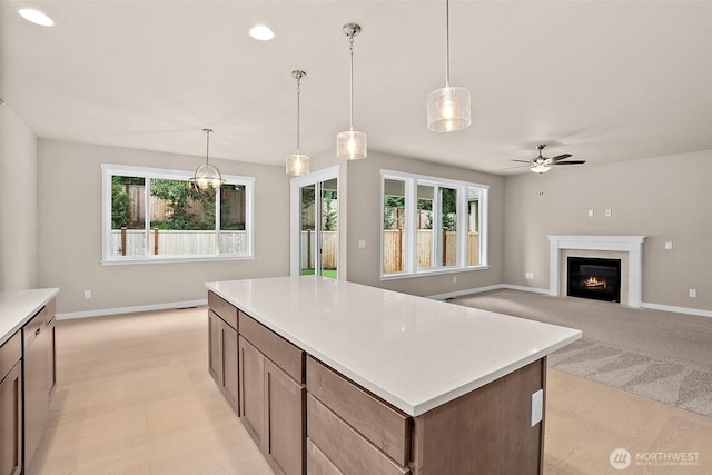 kitchen with healthy amount of natural light, baseboards, a ceiling fan, light countertops, and recessed lighting
