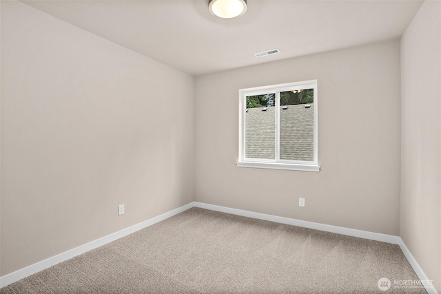 carpeted empty room with baseboards