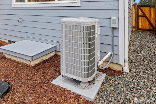 exterior view of central AC unit, a bulkhead entry, and fence