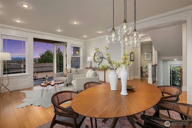 dining area with ornamental molding, wood-type flooring, and recessed lighting