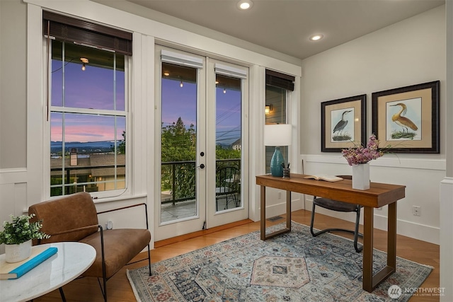 entryway with recessed lighting, wood finished floors, french doors, wainscoting, and an office area