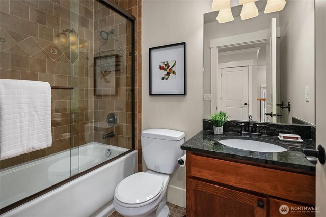 full bath featuring toilet, vanity, and enclosed tub / shower combo