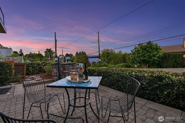 patio terrace at dusk featuring outdoor dining space