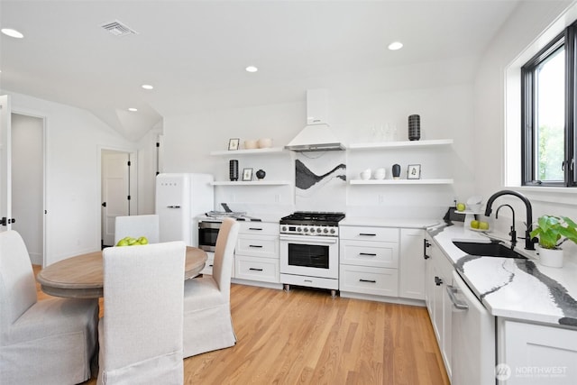 1502 Ironwood Dr, Walla Walla, WA 99362 - kitchen featuring a sink, open shelves, custom exhaust hood, light wood-style flooring, and gas range oven