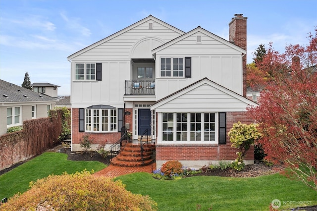1915 35th Ave W, Seattle, WA 98199 - view of front of property with a balcony, board and batten siding, brick siding, and a chimney
