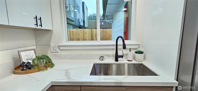 1442 E 31st St, Tacoma, WA 98404 - details with white cabinets, light stone counters, and a sink