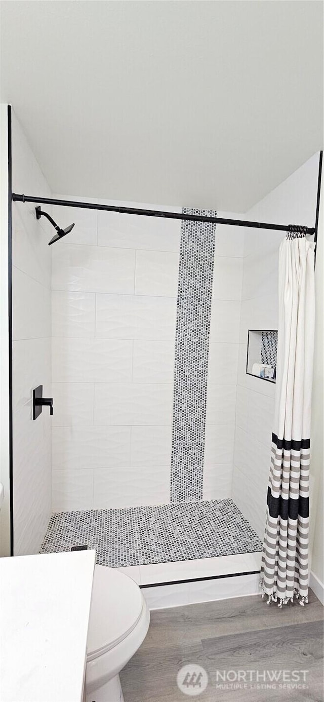 1442 E 31st St, Tacoma, WA 98404 - full bath featuring a stall shower, toilet, and wood finished floors