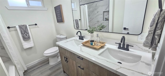 1442 E 31st St, Tacoma, WA 98404 - full bathroom with a sink, baseboards, toilet, and wood finished floors