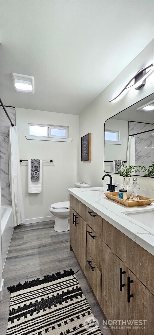 1442 E 31st St, Tacoma, WA 98404 - full bathroom featuring double vanity, toilet, a sink, and wood finished floors