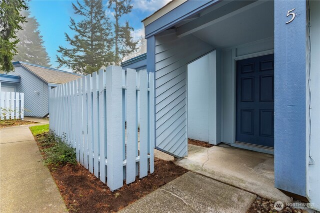doorway to property with fence