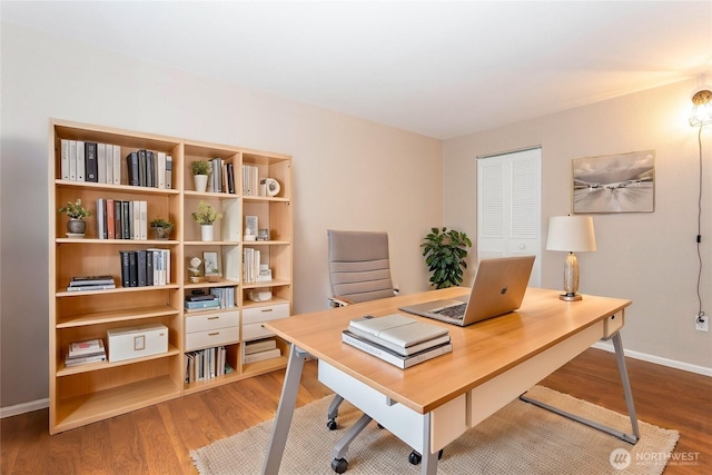 office area with baseboards and wood finished floors