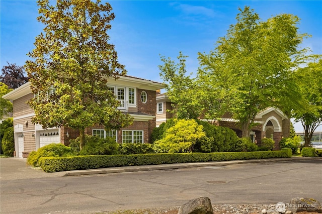 2530 39th Ave E, Seattle, WA 98112 - view of property hidden behind natural elements with a garage and driveway