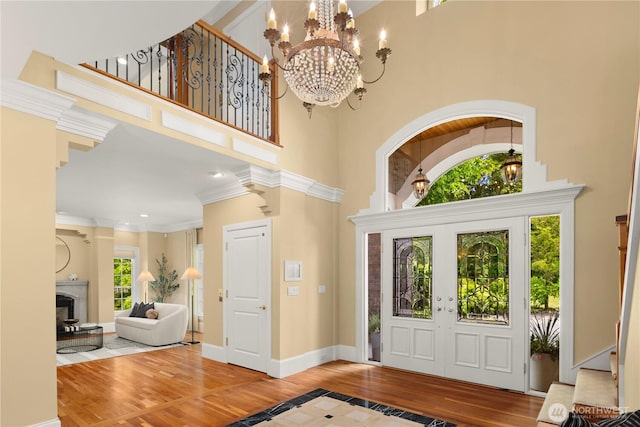 2530 39th Ave E, Seattle, WA 98112 - entryway featuring hardwood / wood-style flooring, a chandelier, stairway, a towering ceiling, and baseboards