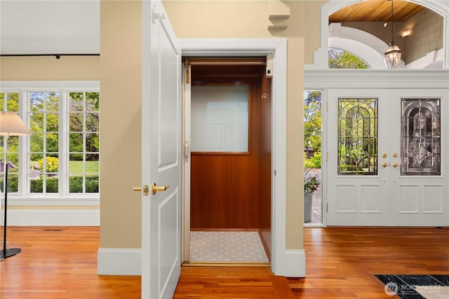 2530 39th Ave E, Seattle, WA 98112 - foyer entrance with wood finished floors, baseboards, and french doors