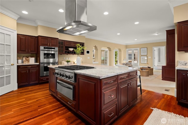 2530 39th Ave E, Seattle, WA 98112 - kitchen featuring island range hood, a warming drawer, stainless steel appliances, ornamental molding, and dark wood finished floors