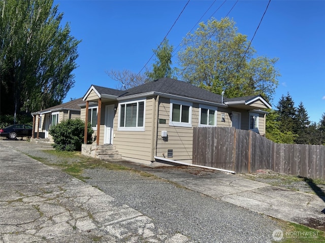 view of front of home featuring fence