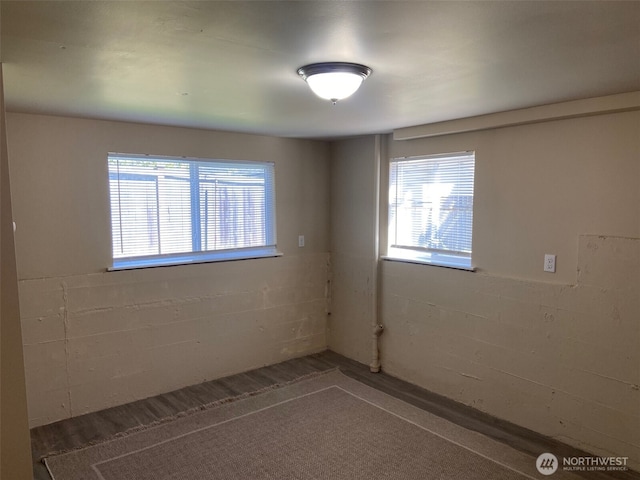 empty room featuring concrete block wall