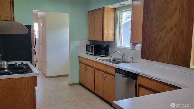 3129 Hudson St, Longview, WA 98632 - kitchen with appliances with stainless steel finishes, a sink, light countertops, light floors, and exhaust hood
