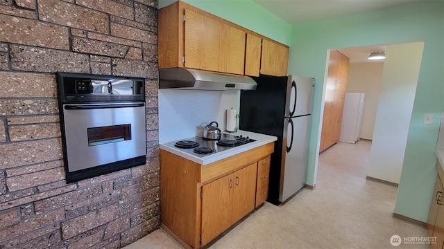 3129 Hudson St, Longview, WA 98632 - kitchen with stainless steel appliances, under cabinet range hood, light countertops, and baseboards