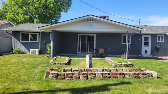 3129 Hudson St, Longview, WA 98632 - back of house with board and batten siding, a yard, and a patio