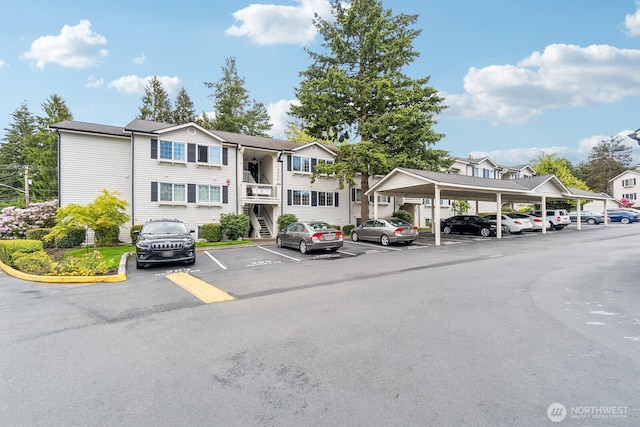12404 E Gibson Rd Unit Q202, Everett, WA 98204 - view of building exterior featuring covered and uncovered parking and a residential view