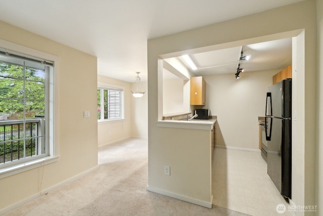 12404 E Gibson Rd Unit Q202, Everett, WA 98204 - kitchen with freestanding refrigerator, baseboards, light countertops, and light colored carpet