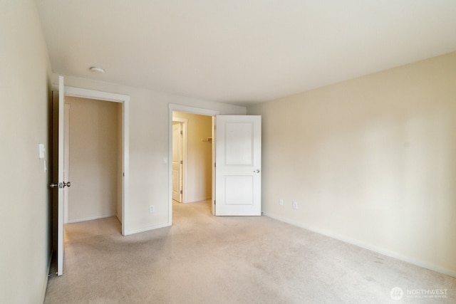 12404 E Gibson Rd Unit Q202, Everett, WA 98204 - unfurnished bedroom featuring carpet floors, baseboards, and a walk in closet