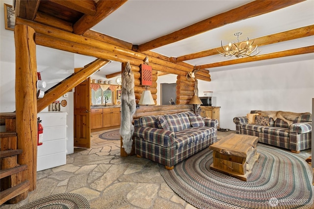 21 Two Springs Rd, Cle Elum, WA 98922 - living area featuring rustic walls, beam ceiling, stairs, a chandelier, and light stone finish floors