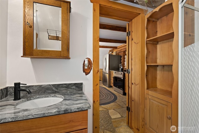 21 Two Springs Rd, Cle Elum, WA 98922 - bathroom with beam ceiling, vanity, and stone finish flooring