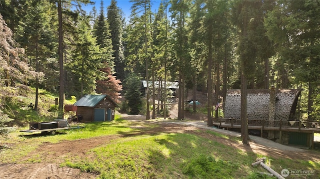 21 Two Springs Rd, Cle Elum, WA 98922 - view of green lawn featuring a shed, an outbuilding, a detached garage, and a wooden deck