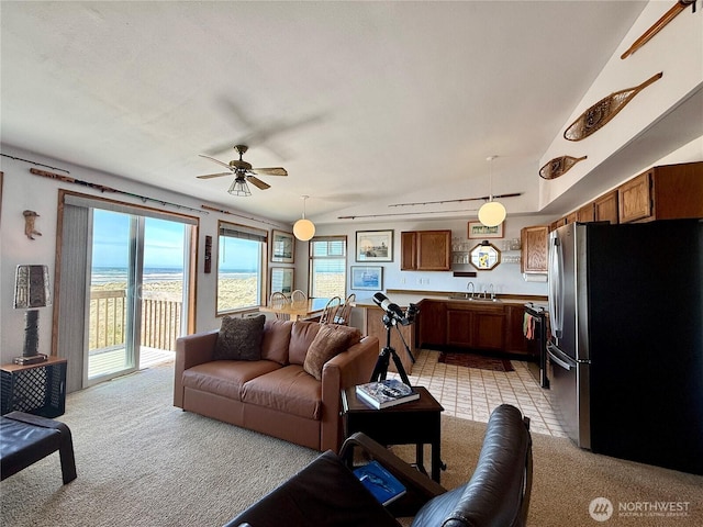 living room featuring ceiling fan, light colored carpet, and vaulted ceiling