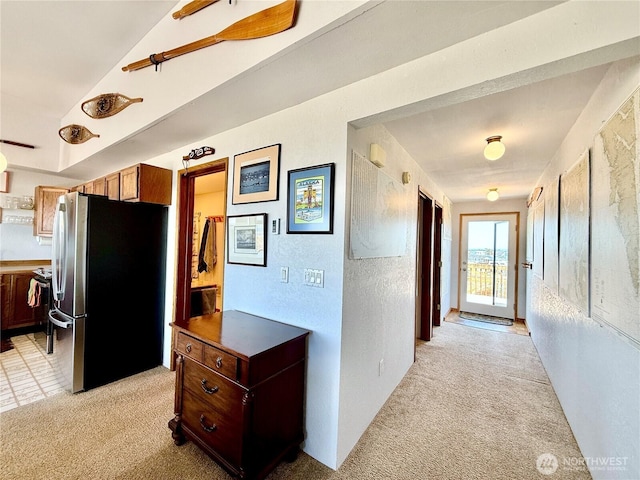 hallway featuring light colored carpet