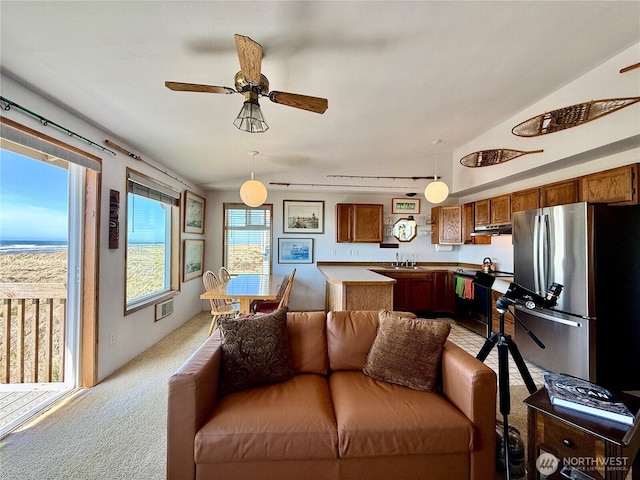 living room with vaulted ceiling, visible vents, ceiling fan, and light carpet