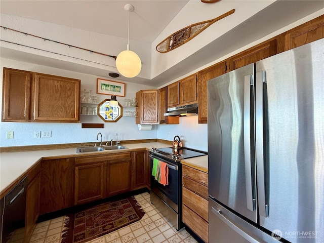 kitchen with a sink, lofted ceiling, stainless steel appliances, brown cabinets, and under cabinet range hood