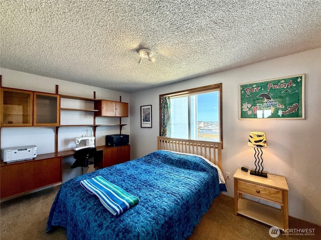 carpeted bedroom with a textured ceiling