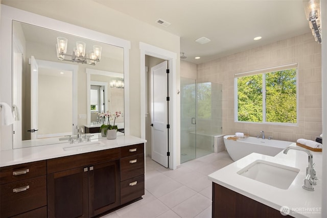 8650 NE Reserve Way, Bainbridge Island, WA 98110 - bathroom with a chandelier, tile patterned flooring, a shower stall, a freestanding bath, and vanity