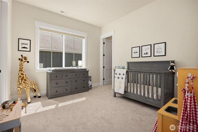 8650 NE Reserve Way, Bainbridge Island, WA 98110 - carpeted bedroom with a nursery area and baseboards