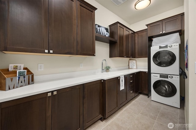 8650 NE Reserve Way, Bainbridge Island, WA 98110 - clothes washing area featuring stacked washer and clothes dryer, a sink, and light tile patterned flooring