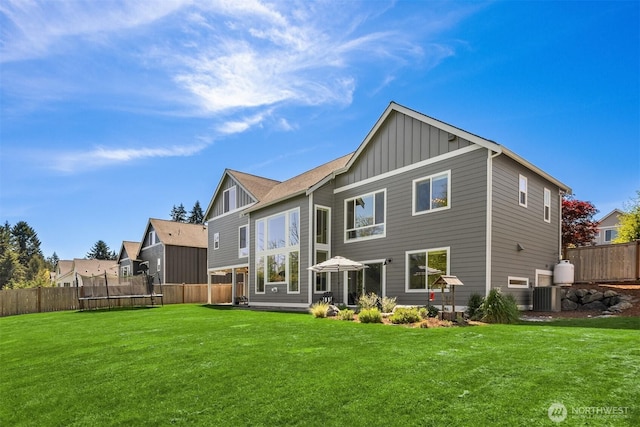 8650 NE Reserve Way, Bainbridge Island, WA 98110 - rear view of property with a trampoline, board and batten siding, and central AC