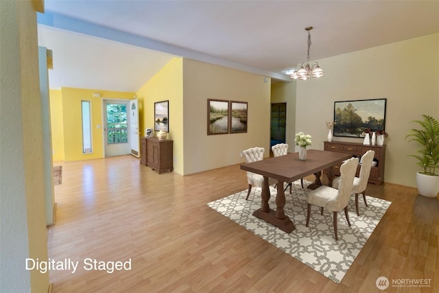 dining room featuring light wood-style flooring and a notable chandelier